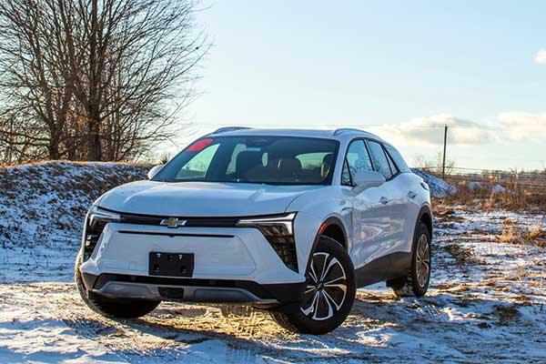 A white Blazer EV parked in a field with snow and frost